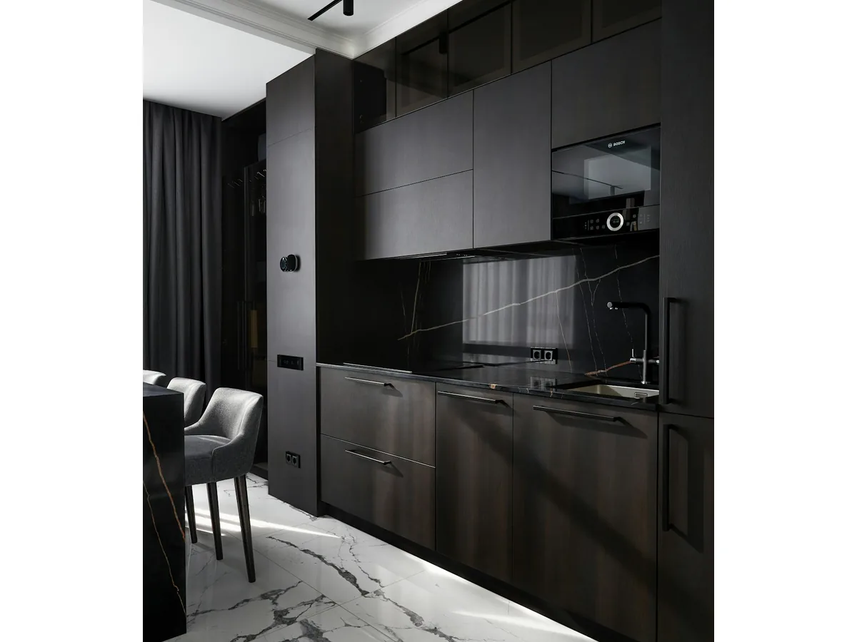 Contemporary dark matt kitchen with marble backsplash and integrated appliances